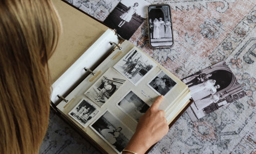 Reminiscing on old photos in family albums - GUESTPIX | #1 QR Code Event Photo Sharing Platform Reminiscing on old photos in family albums